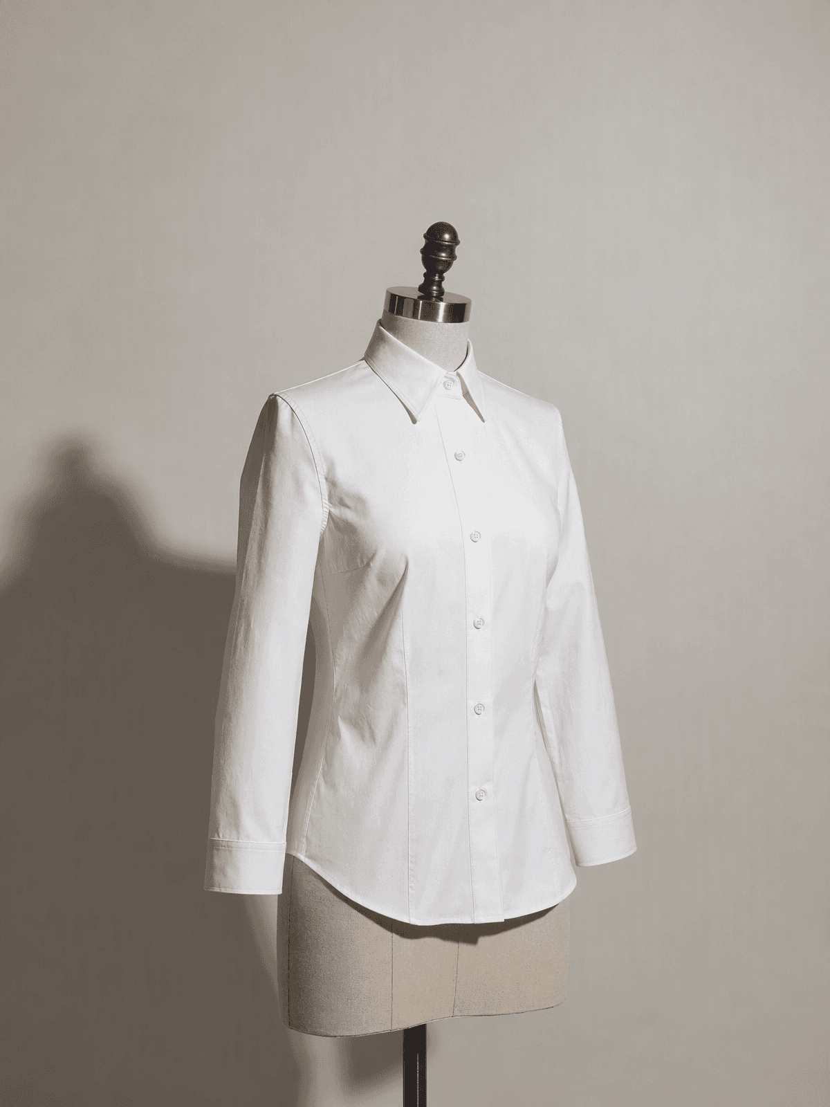 The fitted shirt sewn from this pattern, on a tailor's form under the same light